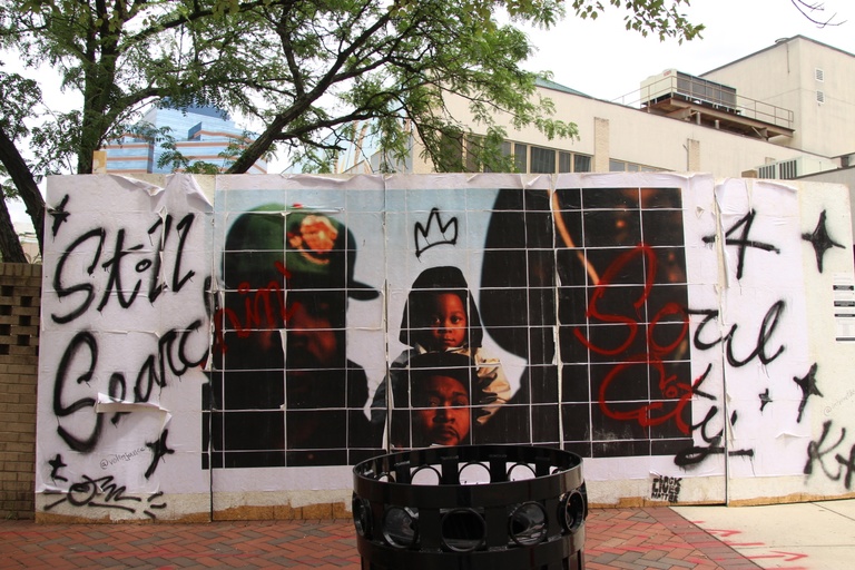 The images of black faces with a crown and the words "still searching 4 soul city."